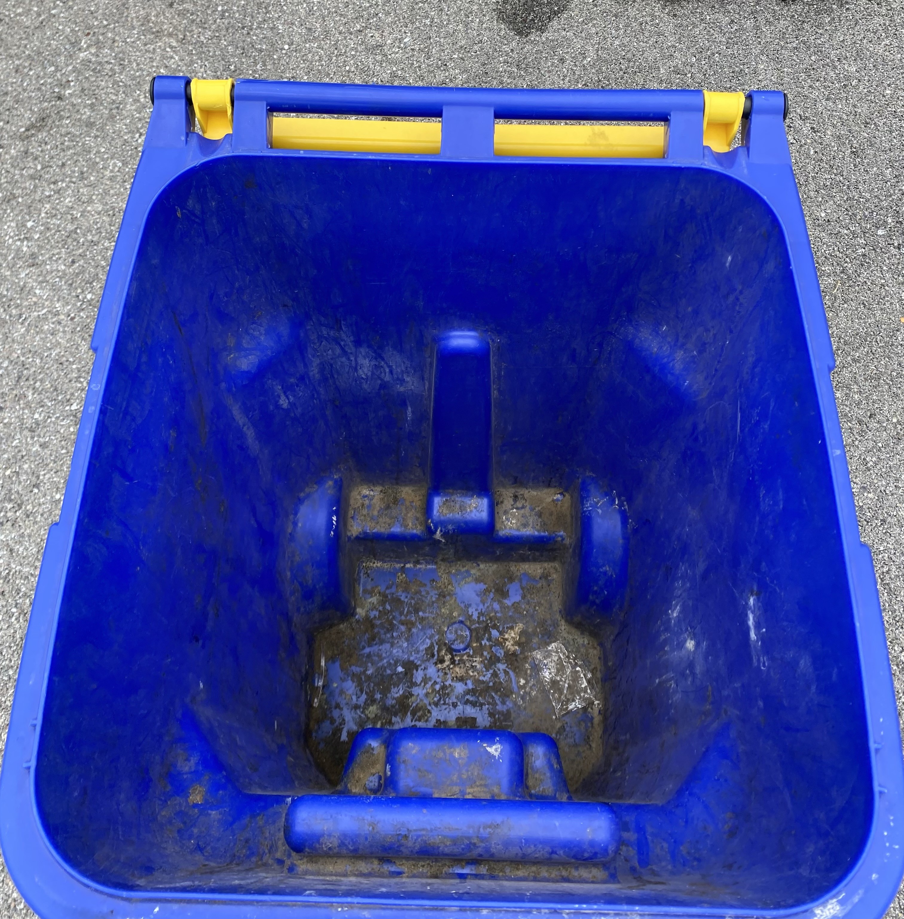 A dirty, grime-covered trash can before XO Power Washing service